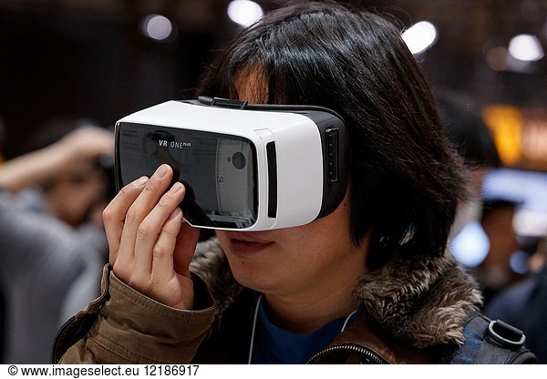 March 3  2018  Yokohama  Japan - A woman tries out a ZEISS VR One Plus (Virtual Reality Headset) at the CP+ Camera & Photo Imaging Show 2018 in Pacifico Yokohama. Japan's largest camera and photo imaging exhibition bring together 1 123 exhibitor booths during the four-day trade show at the Pacifico Yokohama and OSANBASHI Hall. Organizers expect approximately 70 000 visitors until March 4th.