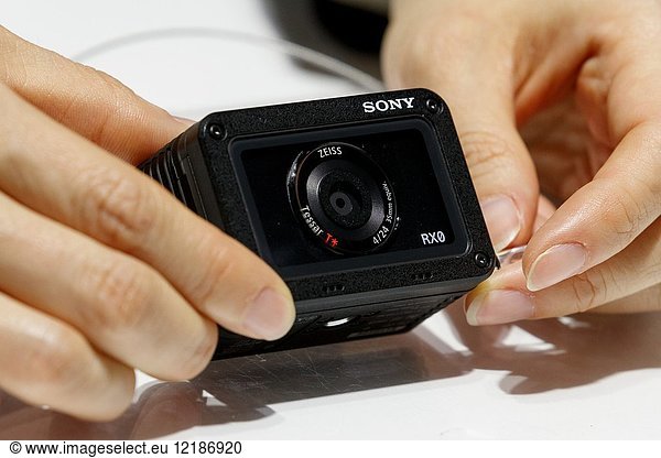 March 3  2018  Yokohama  Japan - An exhibitor shows a tiny camera Sony RX0 during the CP+ Camera & Photo Imaging Show 2018 in Pacifico Yokohama. Japan's largest camera and photo imaging exhibition bring together 1 123 exhibitor booths during the four-day trade show at the Pacifico Yokohama and OSANBASHI Hall. Organizers expect approximately 70 000 visitors until March 4th.