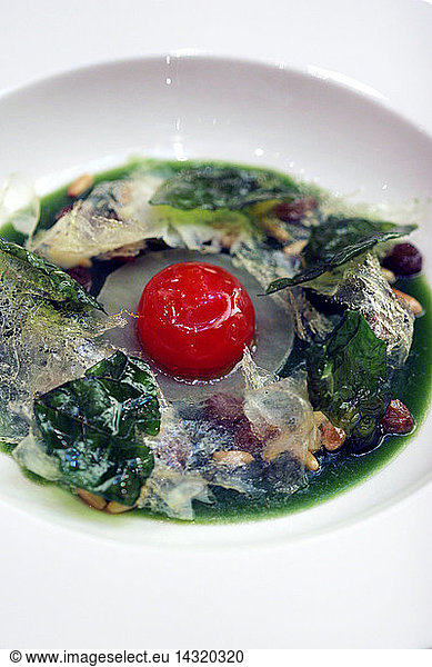 Marinated yolk with spinaches  pine-kernel and raisins  Cracco-Peck restaurant  Milan  Lombardy  Italy