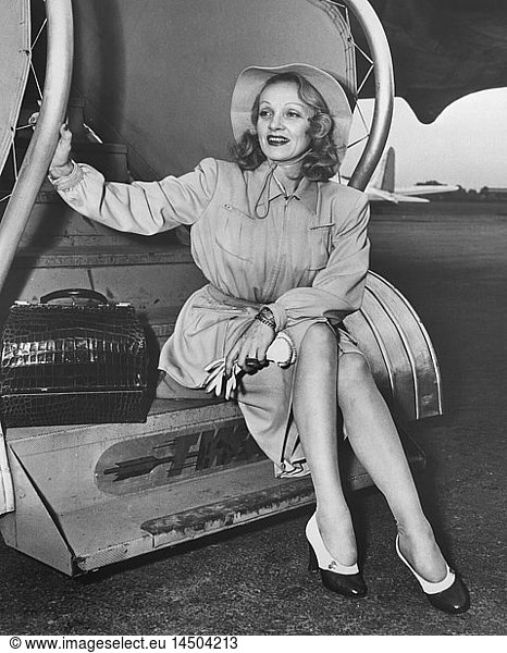 Marlene Dietrich  Publicity Portrait  Sitting on Steps of TWA Airplane en route to Hollywood from New York City  New York  USA  1946