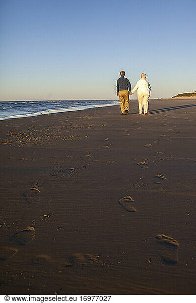 Married couple in their Seventies showing affection at Cold Storage Beach on Cape Cod