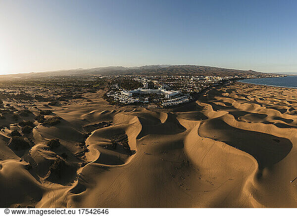 Maspalomas town amidst sand dunes at sunset,  Grand Canary,  Canary Islands,  Spain
