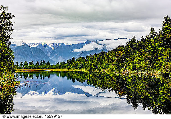 Matheson Lake reflecting the Southern Alps; South Island  New Zealand