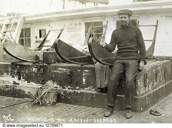 MATTHEW HENSON. Henson on board the 'Roosevelt' alongside the sledges used on Robert E. Peary's successful expedition to the North Pole in 1908-09.