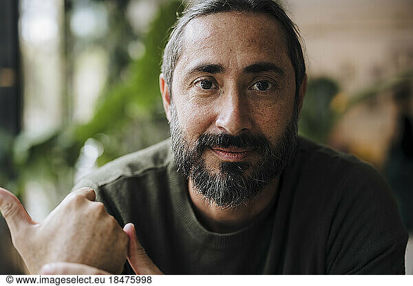 Mature bearded man in cafe