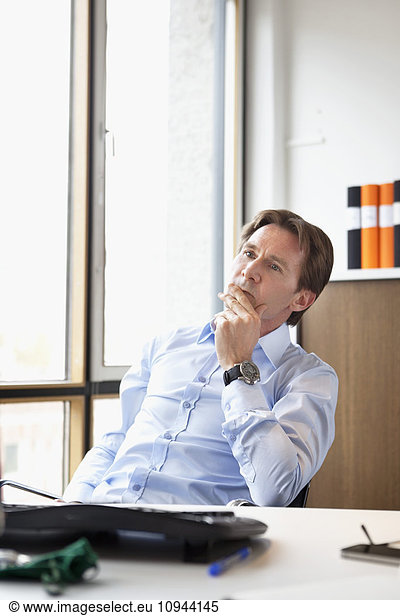 Mature businessman contemplating in office
