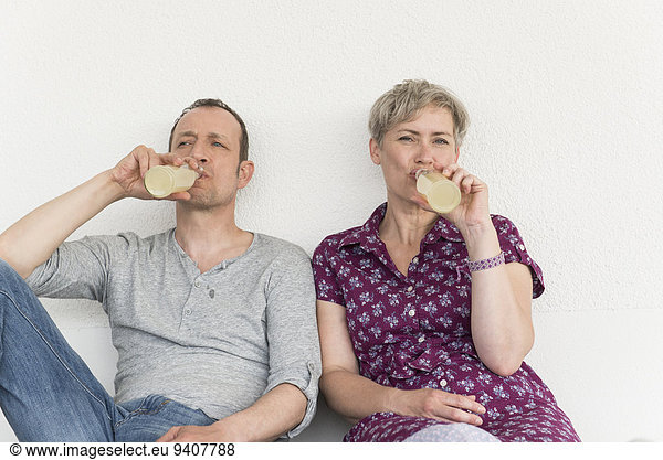Mature couple drinking drink from bottle