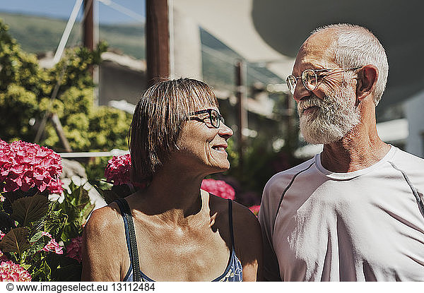 Mature couple looking face to face on sunny day