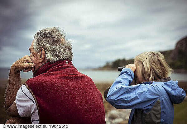 Mature couple looking out over the ocean in Scotland