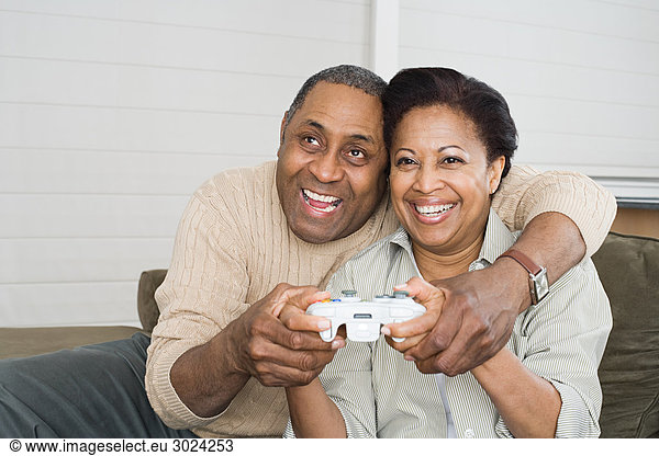 Mature couple playing video game