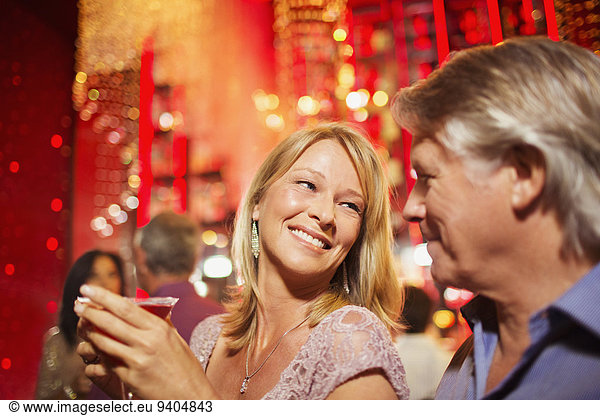 Mature couple smiling in nightclub