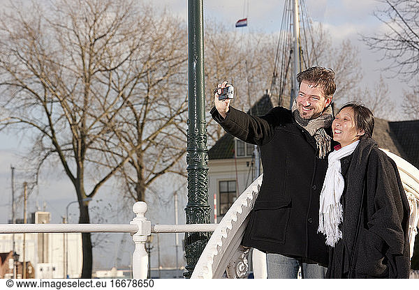 Mature couple taking selfie in Middelburg on a short vaccation