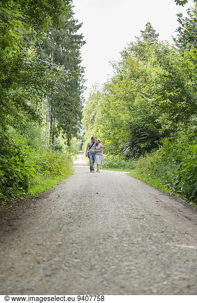 Mature couple walking in forest