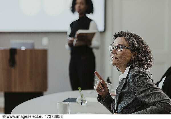 Mature female entrepreneur discussing in training class