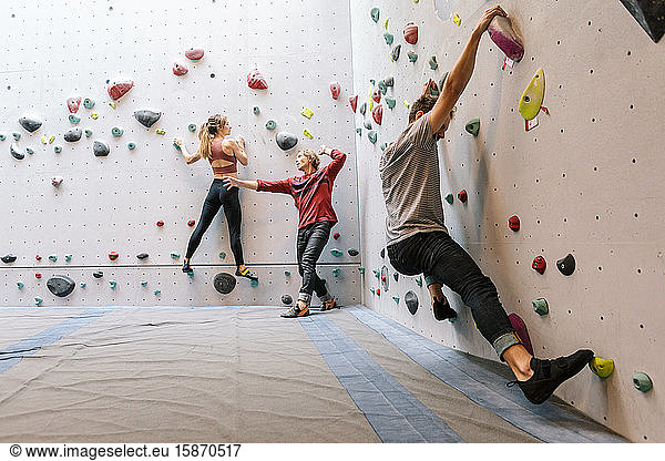 Mature instructor training male and female students in gym