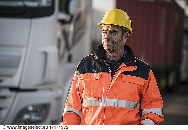 Mature male worker by truck at commercial dock