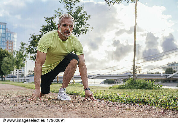 Mature man preparing for run in park