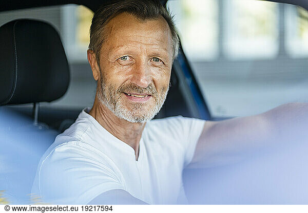 Mature man sitting in car