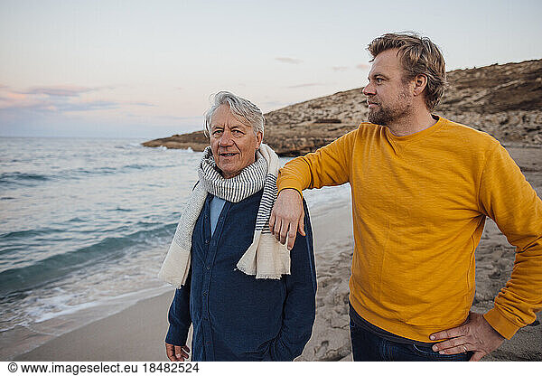 Mature man spending time with father at beach