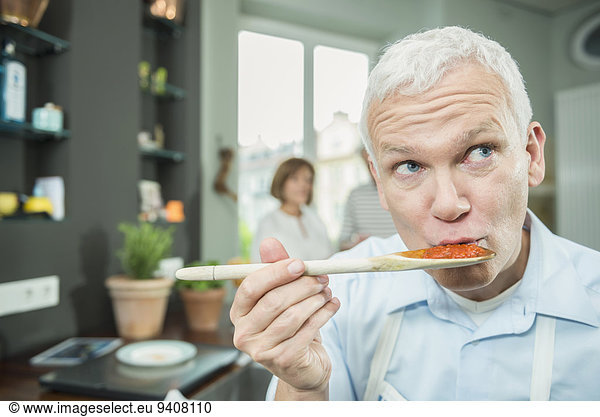 Mature man tasting food  close up