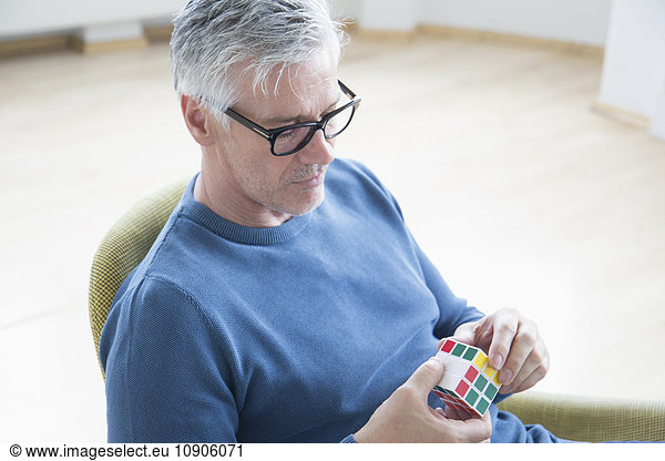 Mature man with Rubik's cube