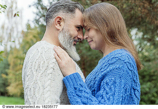 Mature man with woman standing face to face
