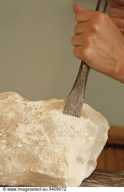 Mature woman carving soapstone