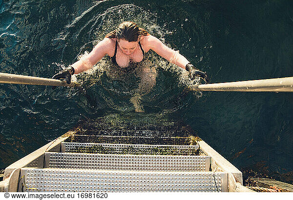 Mature Woman Climbing Up Steps from Cold Water Swim in Denmark