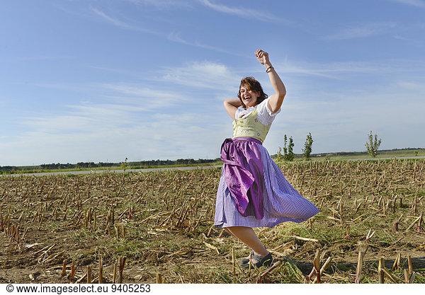 Mature woman dancing in field