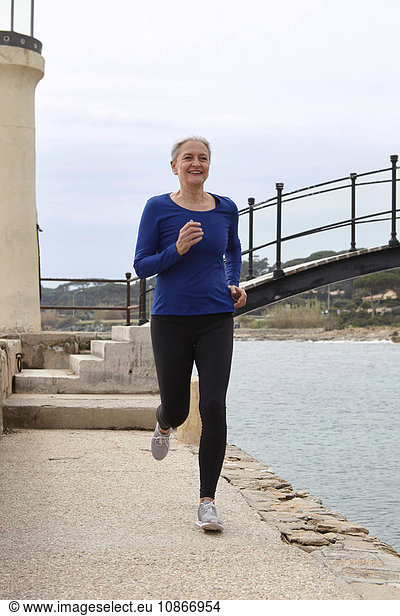 Mature woman exercising  running  outdoors