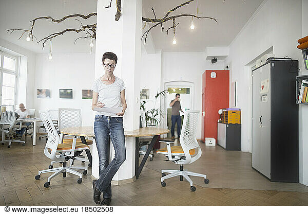 Mature woman looking at paper in the office  Freiburg im Breisgau  Baden-Württemberg  Germany