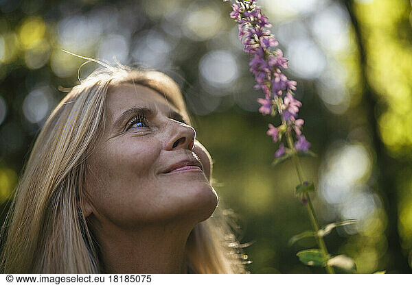 Mature woman looking up in garden