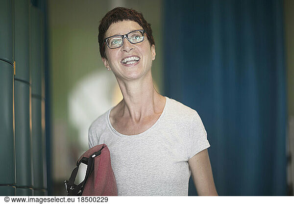 Mature woman standing in the office and laughing  Freiburg im Breisgau  Baden-Württemberg  Germany