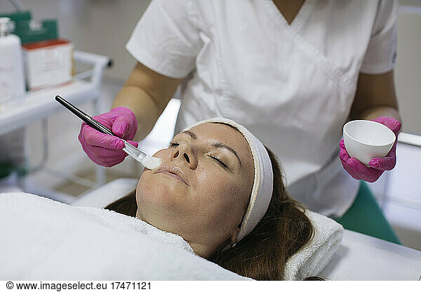 Mature woman taking beauty treatment in salon
