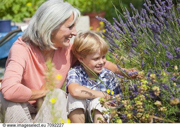 Mature woman with boy in garden