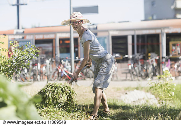 Mature woman working in urban garden
