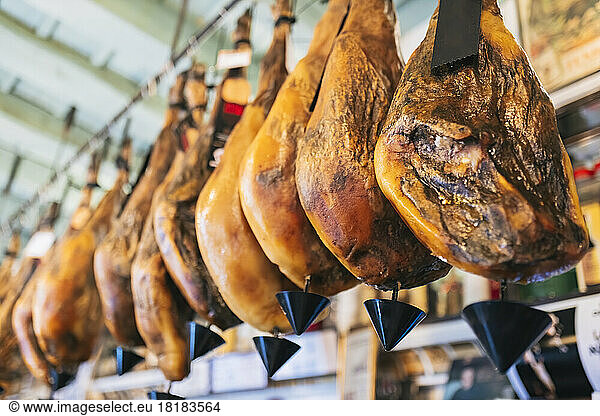 Meat hanging for sale in delicatessen store
