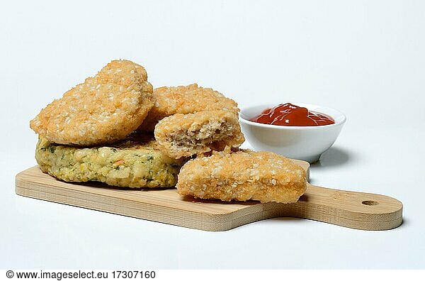 Meat substitute on wooden board and tray with ketchup  imitation meat  Germany  Europe