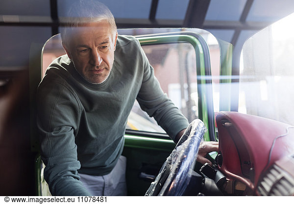 Mechanic examining car interior