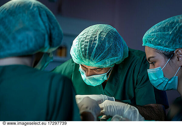 Medical team performing operation. Diverse team of professional