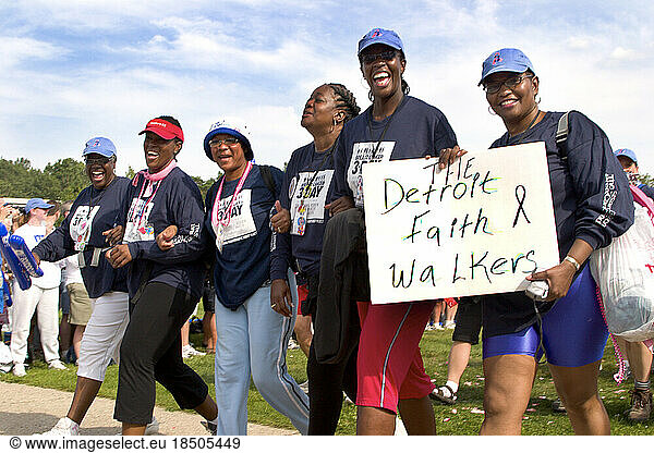 Members of the walker team The Detroit Faith Walkers walk in the parade during closing ceremonies of the Komen Breast Cancer 3-D