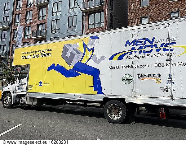Men on the Move  moving truck outside apartment building  Queens  New York.