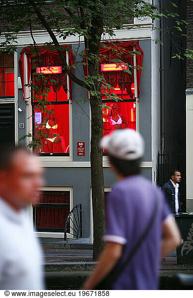 Men passing by prostitutes at the red light district. amsterdam  Holland.