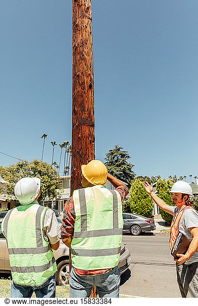 Men Work on Telephone Pole
