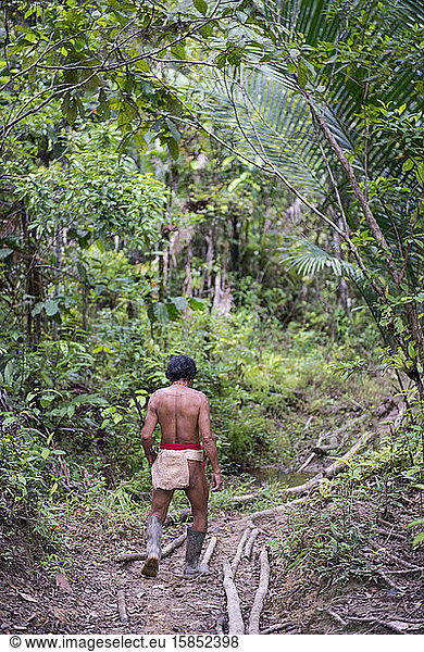 Mentawai tribe man walking through the jungle
