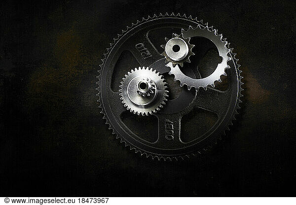 Metal gears lying on dark surface