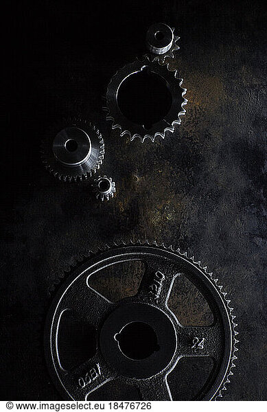 Metal gears lying on dark surface