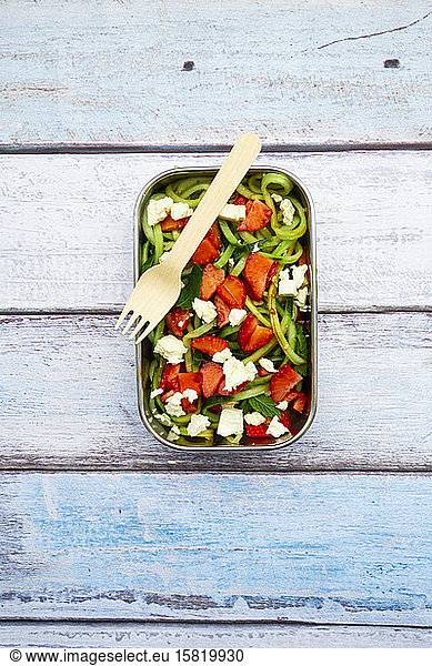 Metal lunch box with fresh mixed vegetarian salad