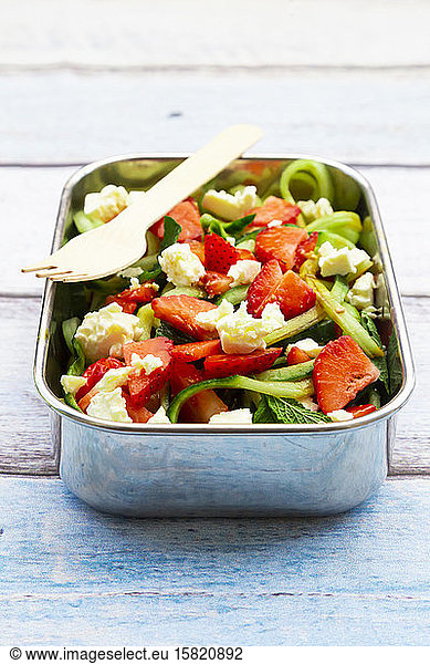 Metal lunch box with fresh mixed vegetarian salad