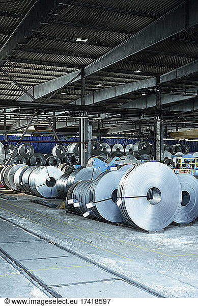 Metal sheet rolls in warehouse